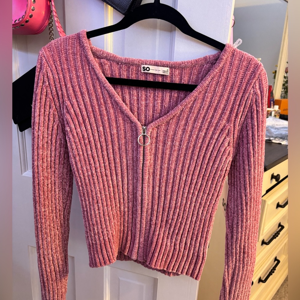 Pink sweater.